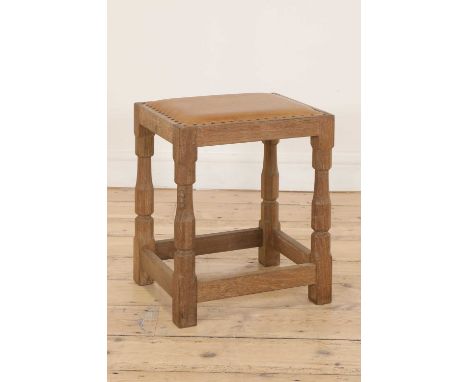 A Robert 'Mouseman' Thompson oak stool, with a tan leather seat, with turned octagonal supports, united with plain stretchers