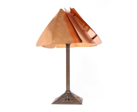 An Arts and Crafts table lamp,in the manner of WAS Benson, the segmented copper shade on a tapering column and a pierced squa