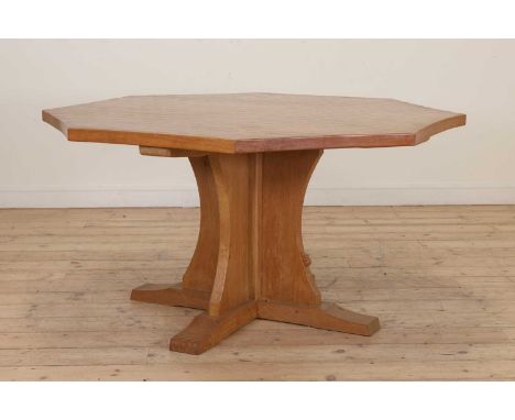 A Robert 'Mouseman' Thompson oak table, with an adzed concave octagonal top, raised on a cruciform stand with adzed edges, an