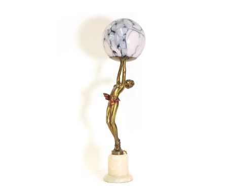 An Art Deco figural cold-painted table lamp,mounted with a marbelised glass globe shade, raised on an onyx plinth, 54cm highC