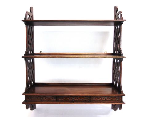 A SET OF CHIPPENDALE STYLE WALL SHELVES  with blind fret-cut drawers, 91.5cm high, 75cm wide.