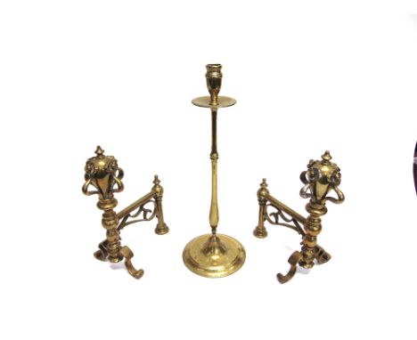A PAIR OF BRASS ANDIRONS  with foliate decoration, and a single brass candlestick 41cm high