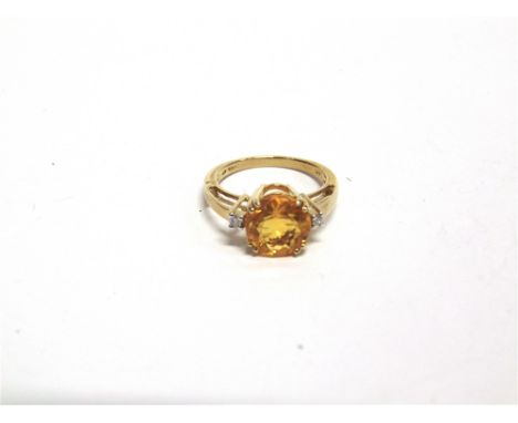 A FIRE OPAL AND DIAMOND THREE STONE 9 CARAT GOLD RING the two brilliant cuts totalling approximately 0.06 carats, finger size