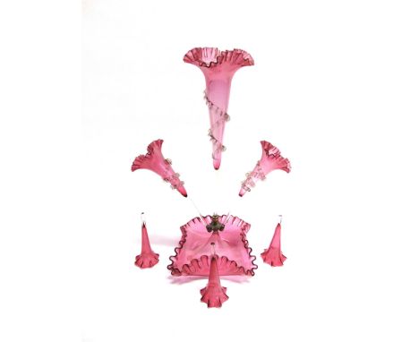 A CRANBERRY GLASS THREE TRUMPET EPERGNE  56cm high; together with three further cranberry glass trumpets