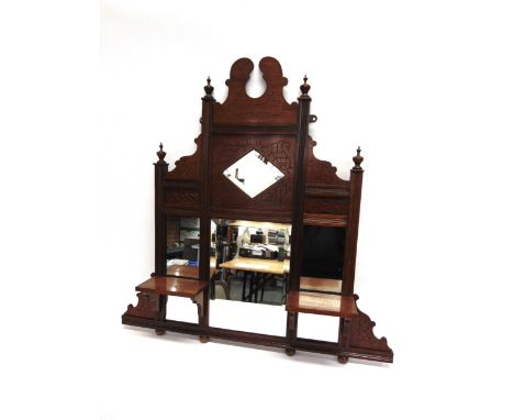 AN EDWARDIAN MAHOGANY OVERMANTEL MIRROR  the central bevelled plate flanked by two smaller plates and a pair of shelves, 85.5