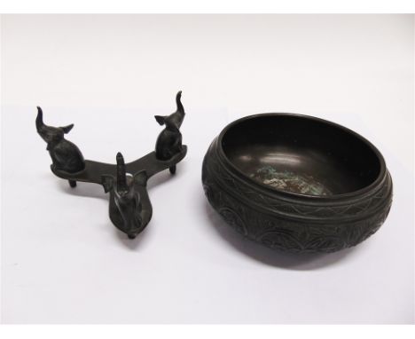 A PATINATED METAL BOWL  with chased foliate decoration, on tripod elephant base, probably Indian, the bowl 20cm diameter, 17c