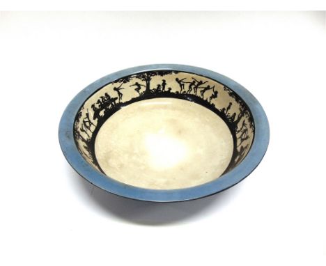 AN EDWARDIAN WASH BASIN  the interior decorated with a continuous band of dancing figures in silouhette, 41.5cm diameter