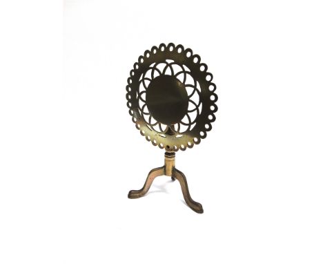 A VICTORIAN BRASS TRIVET  the circular tilt top 28cm diameter, on tripod base