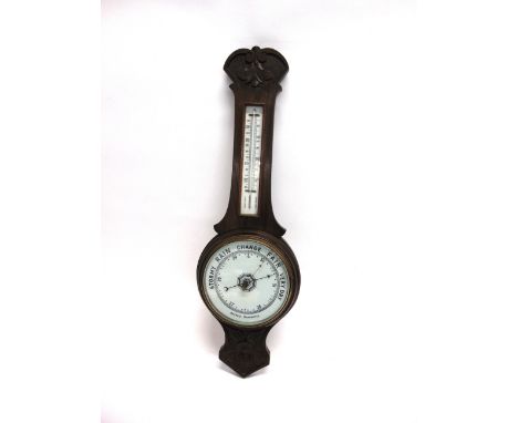 AN OAK ANEROID BAROMETER  late 19th or early 20th century, 80cm high.