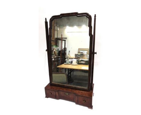 A WALNUT DRESSING TABLE MIRROR  the shaped base fitted with three drawers, 45cm wide 20cm deep 77cm high