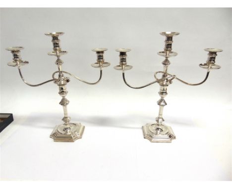 A MATCHED PAIR OF SILVER THREE LIGHT CANDELABRA  by Hawkesworth, Eyre & Co Ltd, London 1908 and 1912, branches part marked fo