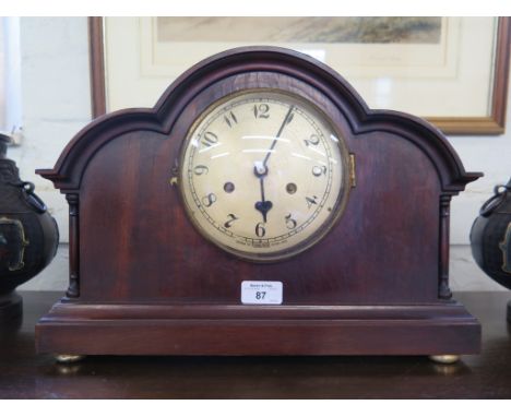 A 1920s mahogany mantel clock, by Tameside, with triple arched and turned spindle applied case on brass pad feet, silvered di