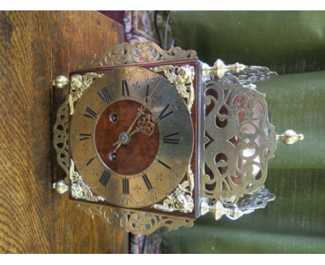 A burr walnut and brass lantern clock, with dolphin form mounts, angel mask spandrels and brass turned feet, the twin train c