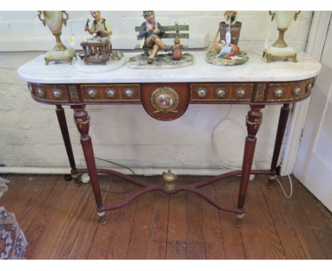 A French style porcelain mounted marble top console table, with reeded tapering legs joined by a shaped stretcher 121cm wide,