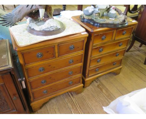 A pair of yewwood crossbanded miniature or bedside chests with two short and three long drawers on bracket feet, 49cm wide (2