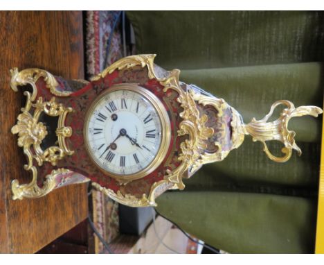 A 19th century French Boullework and ormulu mantle clock, of waisted form with scrolling mounts, the dial inscribed Edward & 