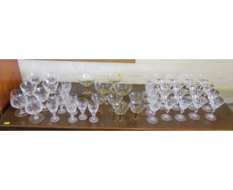 A variety of cut glass sherry glasses, two brandy glasses and other glassware