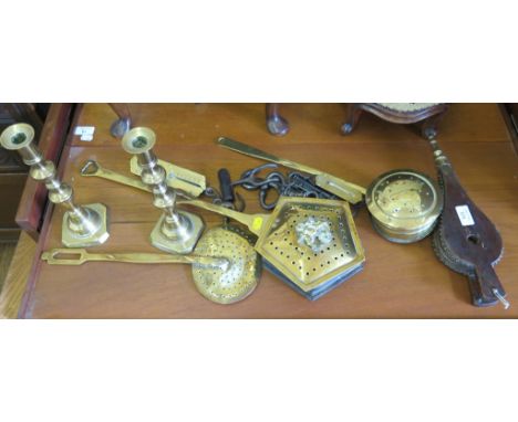 Two brass chestnut roasters, brass scales, a pair of brass candlesticks and other brassware