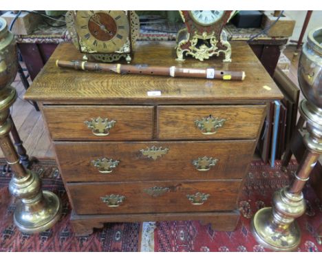 A George III style oak chest of two short and two long drawers on bracket feet, 76cms wide 
