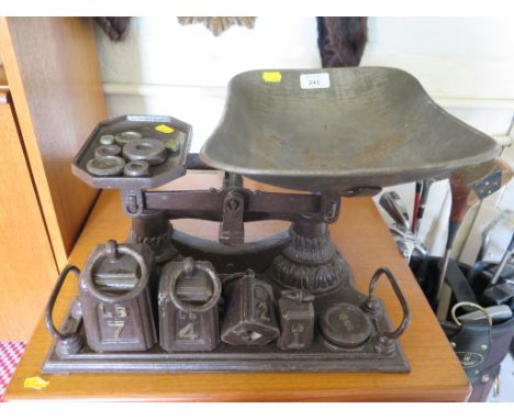 A set of kitchen scales with weights and a set of scientific weights