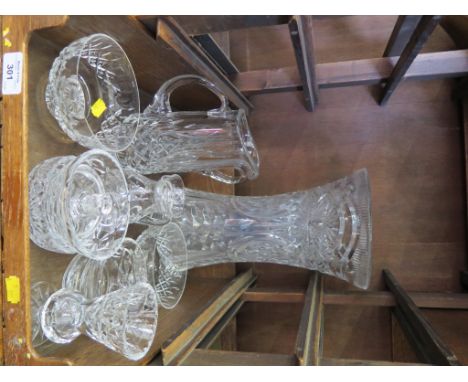 A large waisted cut glass vase, two glass jugs and various dishes