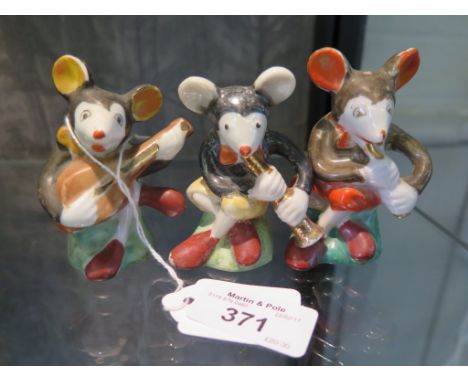 Three Japanese porcelain Mickey Mouse salt and pepper figures playing instruments, 8cm high