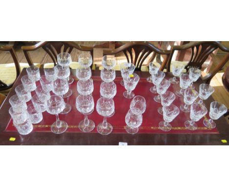 A set of twelve cut glass wine glasses, fourteen other wine glasses, two brandy glasses and eleven whiskey tumblers