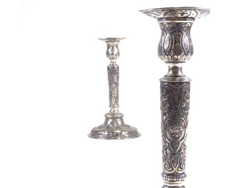 A pair of 19th century German Hanau silver table candlesticks, allover engraved and embossed cherub and floral decoration wit