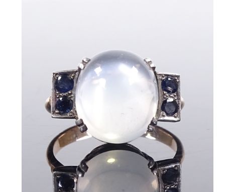 A mid-20th century unmarked gold cabochon moonstone and sapphire dress ring, pierced shoulders and bridge, moonstone length 1