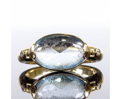 An 18ct gold cabochon aquamarine and diamond dress ring, aqua having faceted back with heart-shaped shoulder settings, settin