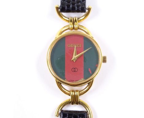 GUCCI - a lady's gold plated stainless steel 6000L quartz wristwatch, red and green dial, 6 jewel movement with calibre 978.0