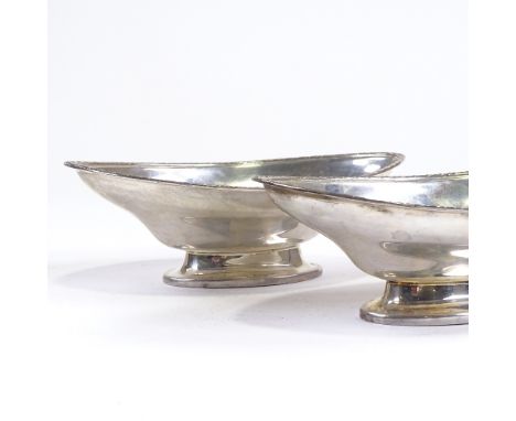 A pair of George V silver boat-shaped pedestal bowls, engraved star rim, by Hukin & Heath, Jubilee hallmarks Birmingham 1934,