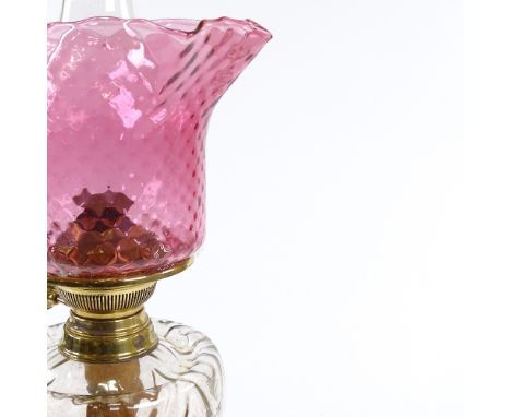 A Victorian brass and coloured glass oil lamp, with frilled cranberry glass shade, height to top of shade 51cm 