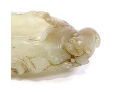 A Chinese pale celadon jade brush washer, in the form of a lily flower with small carved animal handles, probably 19th centur