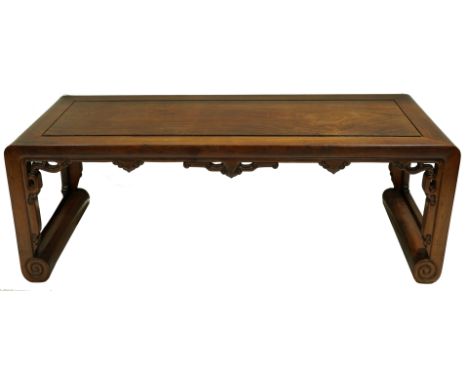 A Chinese Hardwood low table, The indented inset rectangular top above a carved and pierced frieze of opposing cloud scrolls,