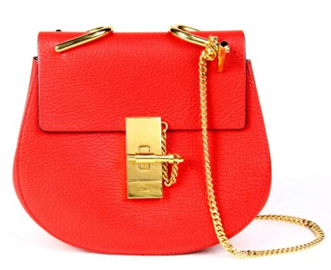 A Chole Drew crossbody bag is crafted of grained lambskin leather in a festive red, the bag features a polished gold chain-li