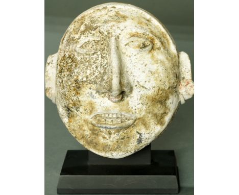 A Pre-Columbian Jalisco, West Mexico, ceramic mask, 200BC-300AD, slipped and polished, having stylized facial features on a w