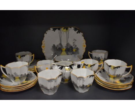 A stunning Shelley 'Sunrise and tall trees' part tea set comprising of eight Queen Anne shaped cups, eight saucers and side p