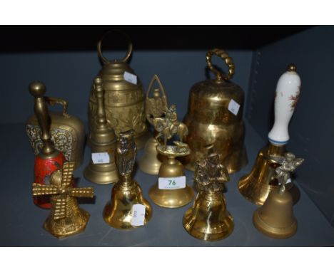A selection of vintage brass bells, including cow bells and souvenir types. One having red enamel detailing.