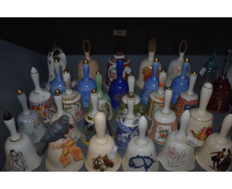 A large collection of ceramic and similar bells, various patterns and designs.