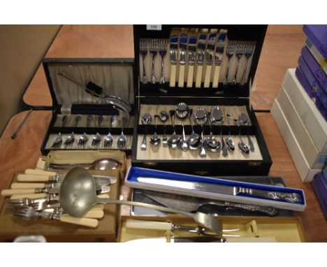 A mixed lot of vintage and some more modern cutlery, including silver plated cake slice, ladle, canteen, and more.