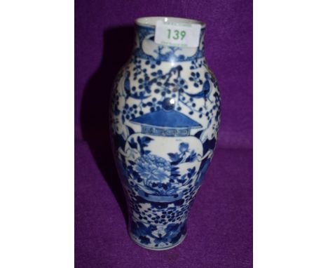 A hard paste Chinese export vase having traditional blue and white palette depicting two students holding a decorated urn bea