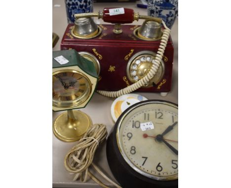 A vintage Genalex bakelite wall clock green plastic and brass mantle clock, and decorative ceramic phone/clock combo.