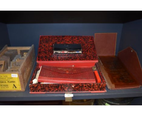 A selection of shop or sign writers tools including brass cut letter set and stencil set