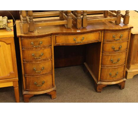 Bevan &amp; Funnell serpentine shaped front mahogany nine drawer pedestal desk and brass telescopic standard lamp (2)