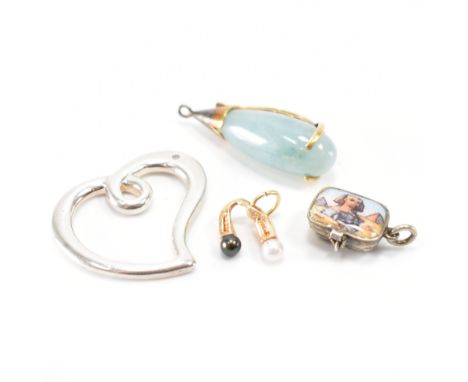 A collection of four vintage pendants. The lot to include a gold pendant set with two pearls (unmarked tests indicate gold), 