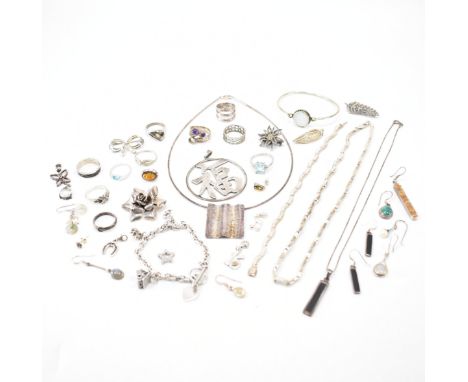 A collection of silver and white metal jewellery. The lot to include a selection of rings brooches, stone set earrings, charm