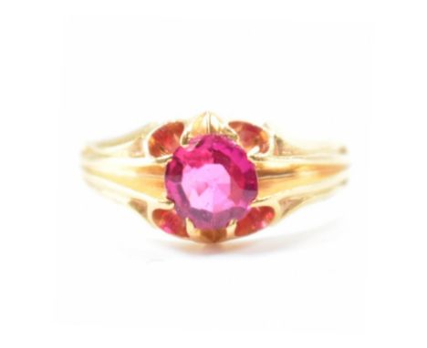 An early 20th century gold and synthetic ruby ring. The ring set with a early synthetic ruby within a scalloped claw setting 