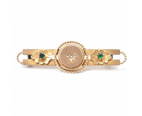 A hallmarked 9ct gold, diamond &amp; emerald bar brooch pin. The brooch having a central old cut star set diamond to a flat h