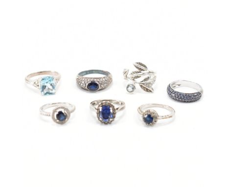 A collection of vintage silver &amp; blue stone dress rings. The lot to include; halo ring, white stones, dark blue stone, te